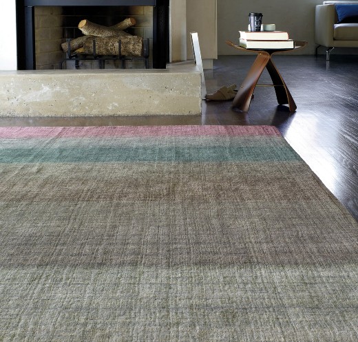 Multi color ombre rug in front of fireplace